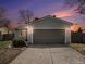 Charming home featuring a two-car garage with a concrete driveway and manicured landscaping at 17802 E Bates Ave, Aurora, CO 80013