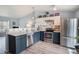 Modern kitchen with stainless steel appliances, granite countertops, and stylish two-tone cabinets at 17802 E Bates Ave, Aurora, CO 80013