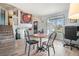 Bright living room featuring hardwood floors, a large window, and staircase access to a loft at 17802 E Bates Ave, Aurora, CO 80013