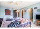 Bright bedroom with wood-look floors, featuring an ensuite bath and a closet at 17802 E Bates Ave, Aurora, CO 80013