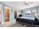 A well-lit bedroom featuring a window, ceiling fan, closet, and an en suite bathroom at 17802 E Bates Ave, Aurora, CO 80013