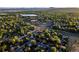 An aerial view showcasing residential area with mature trees, community parks, and nearby shopping centers at 9787 W Ohio Ave, Lakewood, CO 80226