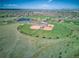 Breathtaking aerial view featuring a beautiful baseball field with a parking lot, pond, and lush greenery landscape at 9787 W Ohio Ave, Lakewood, CO 80226