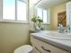 Bright bathroom with a white vanity, stylish fixtures, and a decorative mirror, offering a clean and refreshing space at 9787 W Ohio Ave, Lakewood, CO 80226