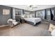 Serene bedroom features plush bedding, neutral tones, and plenty of natural light, creating a peaceful retreat at 9787 W Ohio Ave, Lakewood, CO 80226