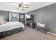 Bedroom featuring gray walls, a ceiling fan, TV, and a comfortable carpet at 9787 W Ohio Ave, Lakewood, CO 80226