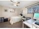 Well-lit bedroom featuring a single bed, desk, and a view from the window at 9787 W Ohio Ave, Lakewood, CO 80226