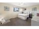 A bright bedroom with neutral decor, a ceiling fan, and two windows at 9787 W Ohio Ave, Lakewood, CO 80226