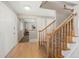 Inviting foyer featuring hardwood floors, a staircase with wood banister, and ample natural light creating a warm welcome at 9787 W Ohio Ave, Lakewood, CO 80226
