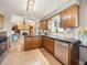 Bright kitchen with wood cabinets, stainless steel appliances, and an open floor plan at 9787 W Ohio Ave, Lakewood, CO 80226