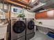 Basement laundry area features a washer and dryer with white utility sink and storage space at 9787 W Ohio Ave, Lakewood, CO 80226