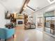 Bright living room with skylights, fireplace, and open access to the enclosed patio at 9787 W Ohio Ave, Lakewood, CO 80226