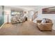 Inviting living room with a staircase, large window, and comfortable seating at 9787 W Ohio Ave, Lakewood, CO 80226