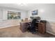Well-lit home office features a wooden desk with stylish decor, creating an ideal workspace for productivity and comfort at 9787 W Ohio Ave, Lakewood, CO 80226