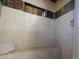 Tiled shower featuring a built-in bench and a convenient niche for toiletries at 9787 W Ohio Ave, Lakewood, CO 80226