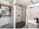 Modern shower with stylish tiling, a rain shower head, and sleek fixtures at 9787 W Ohio Ave, Lakewood, CO 80226