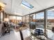 Inviting sunroom with comfortable seating, skylights, and access to a backyard with a hot tub at 9787 W Ohio Ave, Lakewood, CO 80226