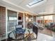 Bright sunroom features skylights, comfortable seating, and a glass table with a backgammon set at 9787 W Ohio Ave, Lakewood, CO 80226