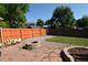 Backyard featuring a fire pit, garden bed, and plenty of space for outdoor living at 21518 E Powers Ln, Centennial, CO 80015