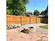 Fenced backyard features a stone fire pit and wood pile at 21518 E Powers Ln, Centennial, CO 80015