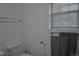 Bathroom featuring chrome towel bars, a toilet, and a window at 21518 E Powers Ln, Centennial, CO 80015