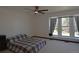 Spacious bedroom with large window, ceiling fan, and neutral carpet and white paint at 21518 E Powers Ln, Centennial, CO 80015