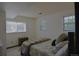 Bright bedroom with multiple windows, a comfortable bed, and simple furnishings at 21518 E Powers Ln, Centennial, CO 80015
