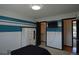 Bedroom featuring white and blue horizontal stripe detail, and a dark interior door at 21518 E Powers Ln, Centennial, CO 80015