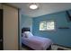Bright bedroom with natural light, soft blue walls and window overlooking the exterior at 21518 E Powers Ln, Centennial, CO 80015