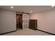 Finished bedroom with neutral carpet and sliding barn door to storage at 21518 E Powers Ln, Centennial, CO 80015