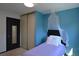 Cozy bedroom featuring bright blue walls and a plush single bed at 21518 E Powers Ln, Centennial, CO 80015