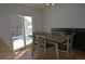 Dining area featuring a wooden table with chairs and views of the deck through sliding glass doors at 21518 E Powers Ln, Centennial, CO 80015