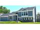 Charming two-story home featuring blue siding, stone accents, well-kept front yard, and mature trees at 21518 E Powers Ln, Centennial, CO 80015
