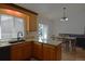 Well-lit kitchen with wooden cabinets, granite countertops, and modern appliances, open to the dining area at 21518 E Powers Ln, Centennial, CO 80015