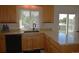 Bright and airy kitchen with granite countertops, wooden cabinets, and modern black appliances at 21518 E Powers Ln, Centennial, CO 80015