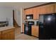 Charming kitchen with black appliances and plenty of cabinet space, leading to the stairs at 21518 E Powers Ln, Centennial, CO 80015