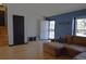 Cozy living room with hardwood floors, a comfortable sofa, and lots of natural light at 21518 E Powers Ln, Centennial, CO 80015