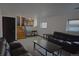Living room showcasing stairs, a sofa, and natural light from two windows at 21518 E Powers Ln, Centennial, CO 80015