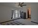 Spacious primary bedroom with a ceiling fan, large window and dark furnishings at 21518 E Powers Ln, Centennial, CO 80015