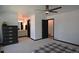 Spacious primary bedroom with a ceiling fan, bathroom and dark furnishings at 21518 E Powers Ln, Centennial, CO 80015
