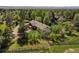 Aerial shot of a brick home with wooden deck in a lush, green neighborhood at 5460 S Olive St, Greenwood Village, CO 80111
