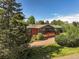 Charming brick home with a large wooden deck and mature trees at 5460 S Olive St, Greenwood Village, CO 80111