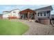 Backyard with a patio seating area, hot tub, and well-maintained artificial grass at 15776 Native Willow Dr, Monument, CO 80132