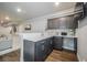 View of the basement bar featuring gray cabinets, light countertops, and wood floors at 15776 Native Willow Dr, Monument, CO 80132