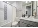 Elegant bathroom showcasing a bathtub with shower, modern vanity, and sleek fixtures at 15776 Native Willow Dr, Monument, CO 80132