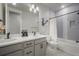 Modern bathroom with double vanity, sleek fixtures, and tiled shower/tub combination at 15776 Native Willow Dr, Monument, CO 80132