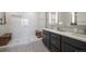 Modern bathroom featuring dual sinks, a glass-enclosed shower, and contemporary fixtures at 15776 Native Willow Dr, Monument, CO 80132