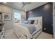 Chic bedroom with a navy accent wall, a plush bed, and a window with neighborhood views at 15776 Native Willow Dr, Monument, CO 80132