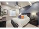 Inviting bedroom with ceiling fan, accent wall, and soft lighting for a relaxing ambiance at 15776 Native Willow Dr, Monument, CO 80132