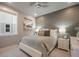 Cozy bedroom with accent wall, ceiling fan, and plush bedding for a relaxing retreat at 15776 Native Willow Dr, Monument, CO 80132